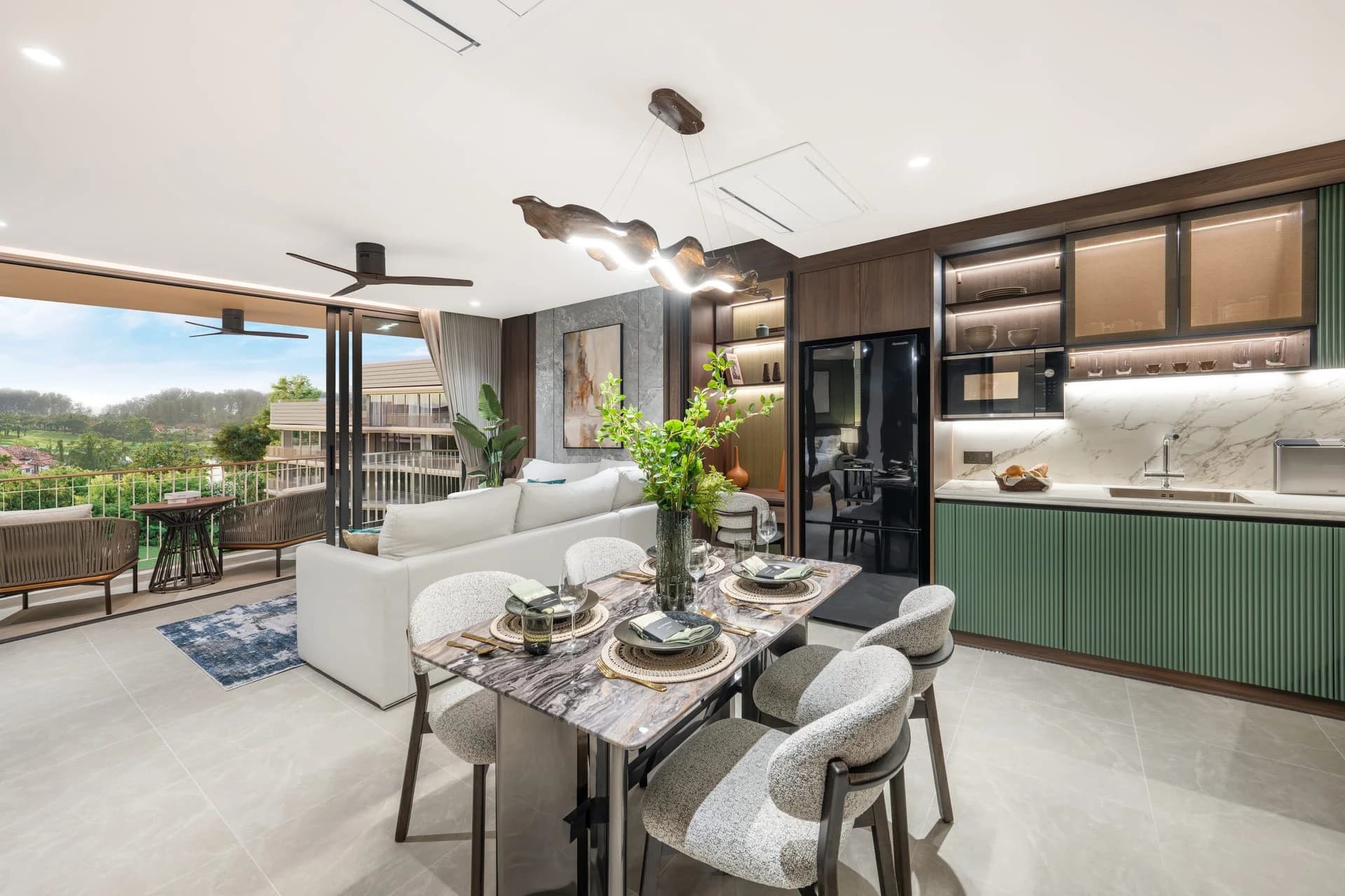 The show unit: living and dining area with green kitchen cabinets and a balcony view